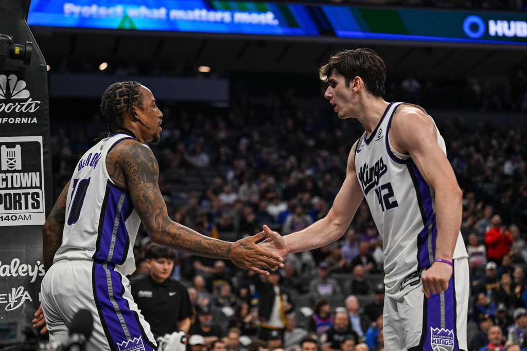 Sacramento Kings guard DeMar DeRozan (10) and teammate Maxime Raynaud (42) high five after an and one foul during the first half of an NBA basketball game, Wednesday, Nov. 5, 2025, in Sacramento, Calif. (AP Photo/Justine Willard)