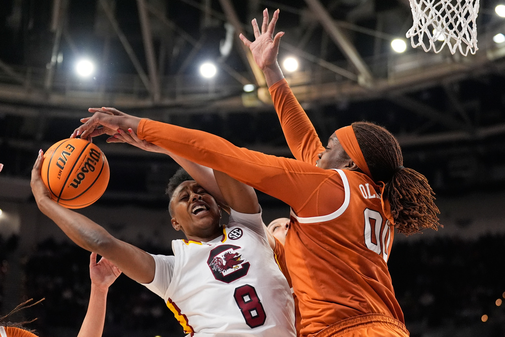 Texas center Kyla Oldacre blocks a shot by South Carolina forward Joyce Edwards during the second half of an NCAA college basketball game in the final of the Southeastern Conference tournament, Sunday, March 8, 2026, in Greenville, S.C. (AP Photo/Chris Carlson)