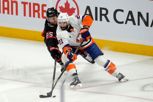 Ottawa Senators defenseman Jake Sanderson (85) pressures New York Islanders center Kyle Palmieri (21) during the first period of an NHL hockey game in Ottawa, Ontario, Saturday, Oct. 18, 2025. (Adrian Wyld/The Canadian Press via AP) Ottawa Senators defenseman Jake Sanderson (85) pressures New York Islanders center Kyle Palmieri (21) during the first period of an NHL hockey game in Ottawa, Ontario, Saturday, Oct. 18, 2025. (Adrian Wyld/The Canadian Press via AP)