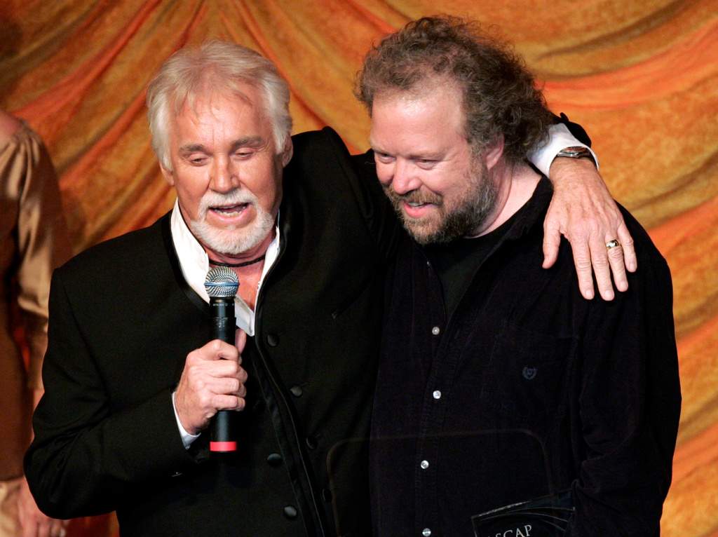 FILE - Kenny Rogers, left, presents the ASCAP Creative Achievement Award to songwriter Don Schlitz at the ASCAP Country Music Awards in Nashville, Tenn., Monday, Oct. 15, 2007. (AP Photo/Mark Humphrey, File)
