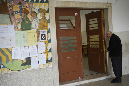 A man waits his turn to vote next to a mural from Portugal's fascist period at a polling station for Portugal's municipal elections in Lisbon, Sunday, Oct. 12, 2025. (AP Photo/Armando Franca) A man waits his turn to vote next to a mural from Portugal's fascist period at a polling station for Portugal's municipal elections in Lisbon, Sunday, Oct. 12, 2025. (AP Photo/Armando Franca)