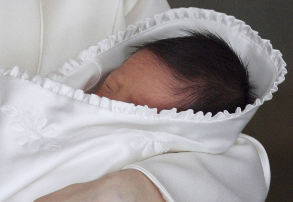 FILE - Japan's newborn Prince Hisahito sleeps in the arms of his mother Crown Princess Kiko as he leaves a Tokyo hospital Sept. 15, 2006. (AP Photo/Itsuo Inouye, Pool, File)