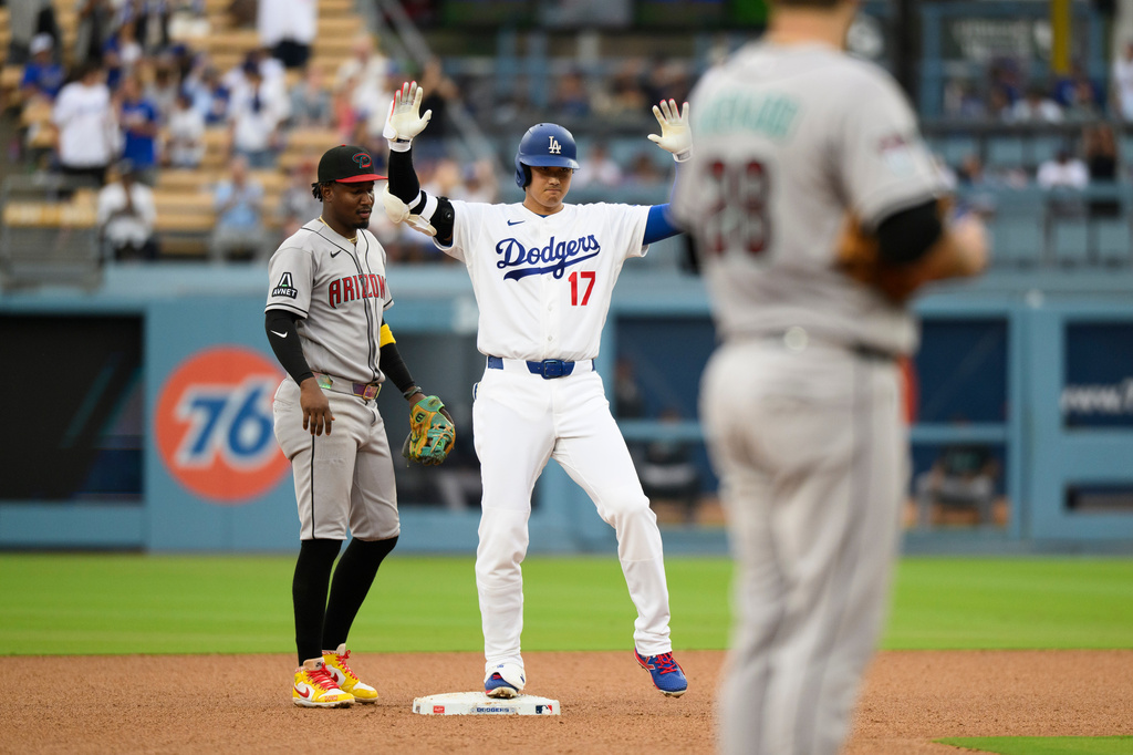 Los Angeles Dodgers' Shohei Ohtani (17) celebrates after hitting a double a double during the third inning of a baseball game against the Arizona Diamondbacks in Los Angeles, Sunday, July 12, 2026. (AP Photo/Kyusung Gong)