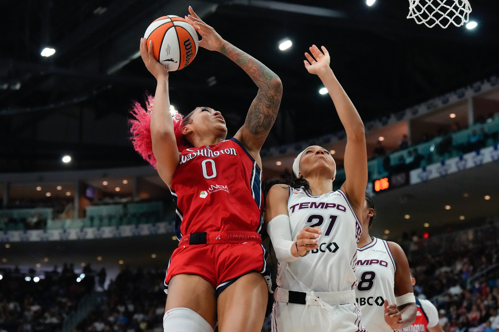 Washington Mystics' Shakira Austin (0) shoots on Toronto Tempo's Isabelle Harrison (21) during the second half of a WNBA basketball game in Toronto on Tuesday, July 14, 2026. (Chris Young/The Canadian Press via AP)