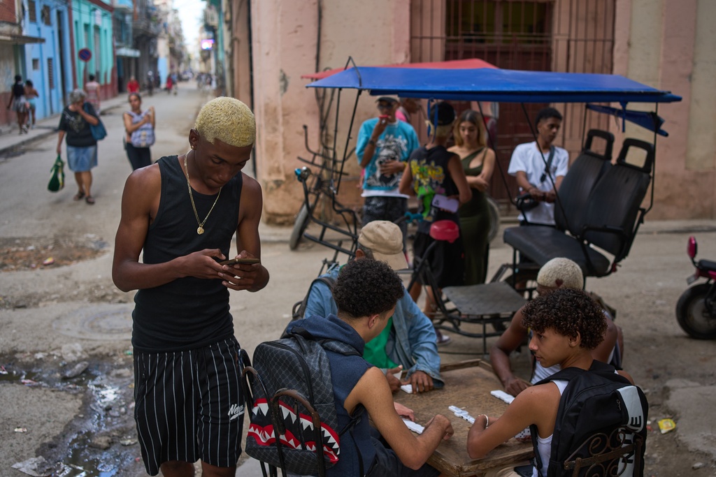 People play dominoes on the street in Havana, Wednesday, Feb. 18, 2026. (AP Photo/Ramon Espinosa)