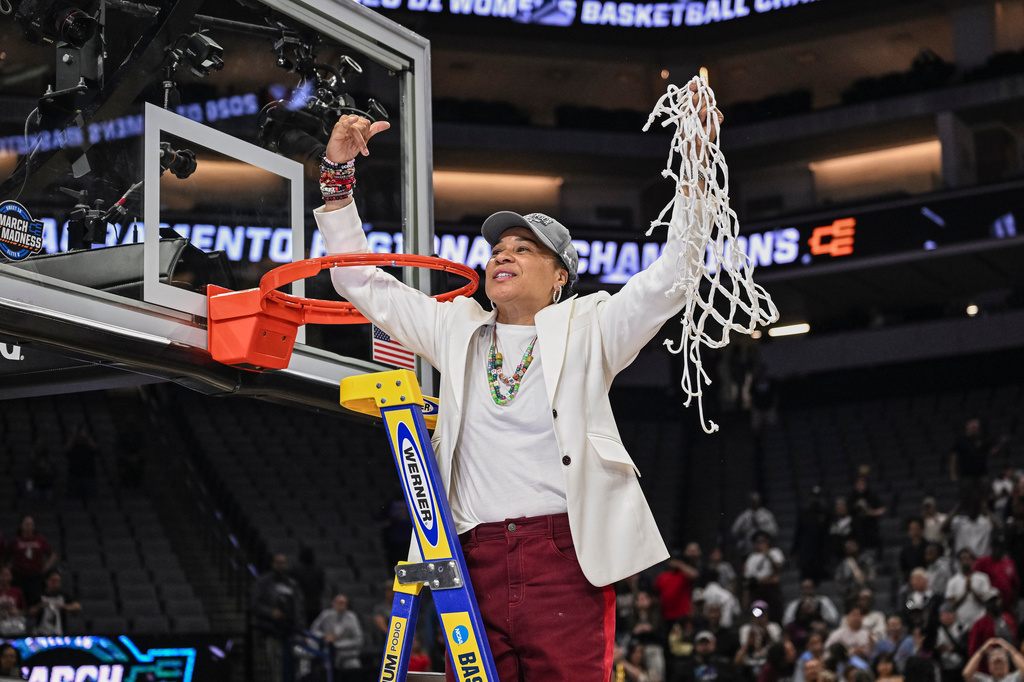 South Carolina head coach Dawn Staley celebrates cutting down the net after South Carolina beats TCU in the Elite Eight of the NCAA college basketball tournament Monday, March 30, 2026, in Sacramento, Calif. (AP Photo/Justine Willard)