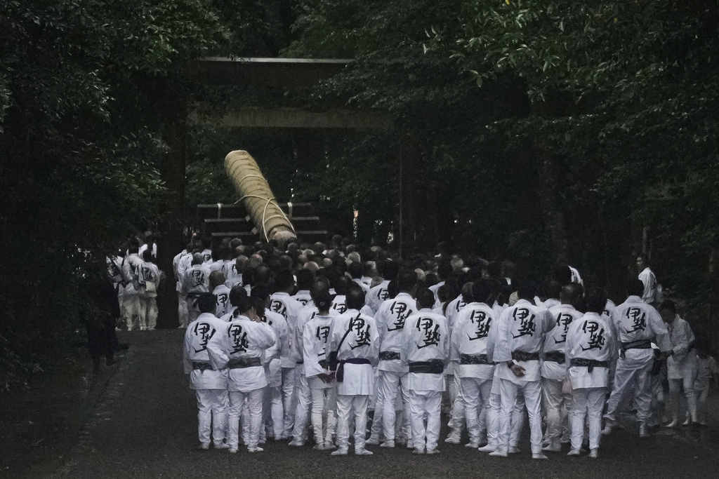 People pull a sacred timber into the Ise Jingu shrine complex, as others follow during Mihishirogi Hoeishiki, a ceremony of the Shikinen Sengu ritual to rebuild its main structures for Shinto deities, in Ise, central Japan, Tuesday, June 10, 2025. (AP Photo/Hiro Komae)