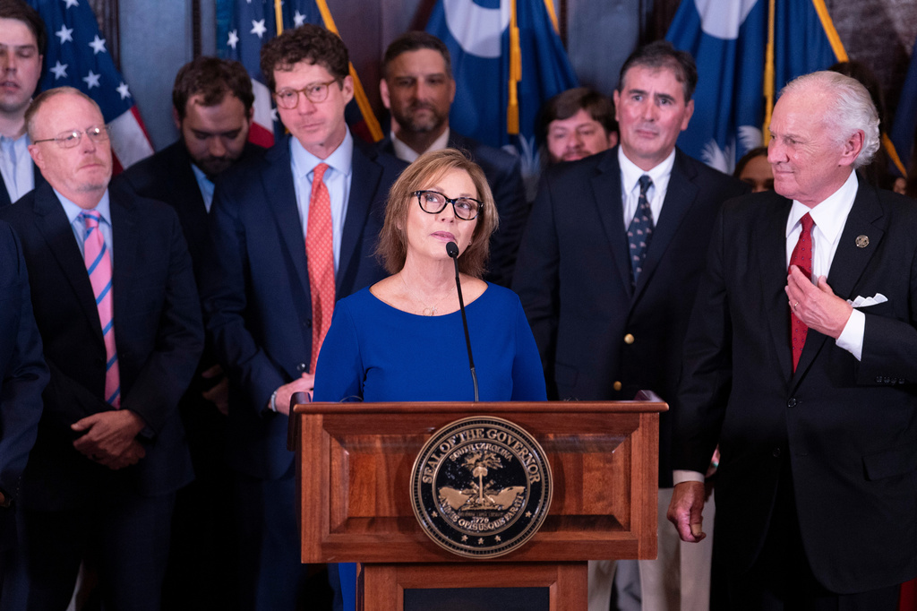 Newly appointed U.S. interim Senator, Darline Graham Nordone, with South Carolina Gov. Henry McMaster, right, speaks to members of the press after being appointed to fill the vacancy created by the passing of her brother, U.S. Senator Lindsey Graham, at the statehouse Monday, July 13, 2026, in Columbia, S.C. (AP Photo/Sean Rayford)