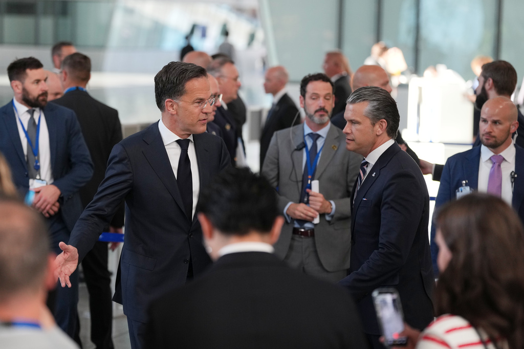 United States Defense Secretary Pete Hegseth, center right, and NATO Secretary General Mark Rutte, center left, arrive for a media conference during a meeting of NATO defense ministers at NATO headquarters in Brussels, Thursday, June 18, 2026. (AP Photo/Virginia Mayo)