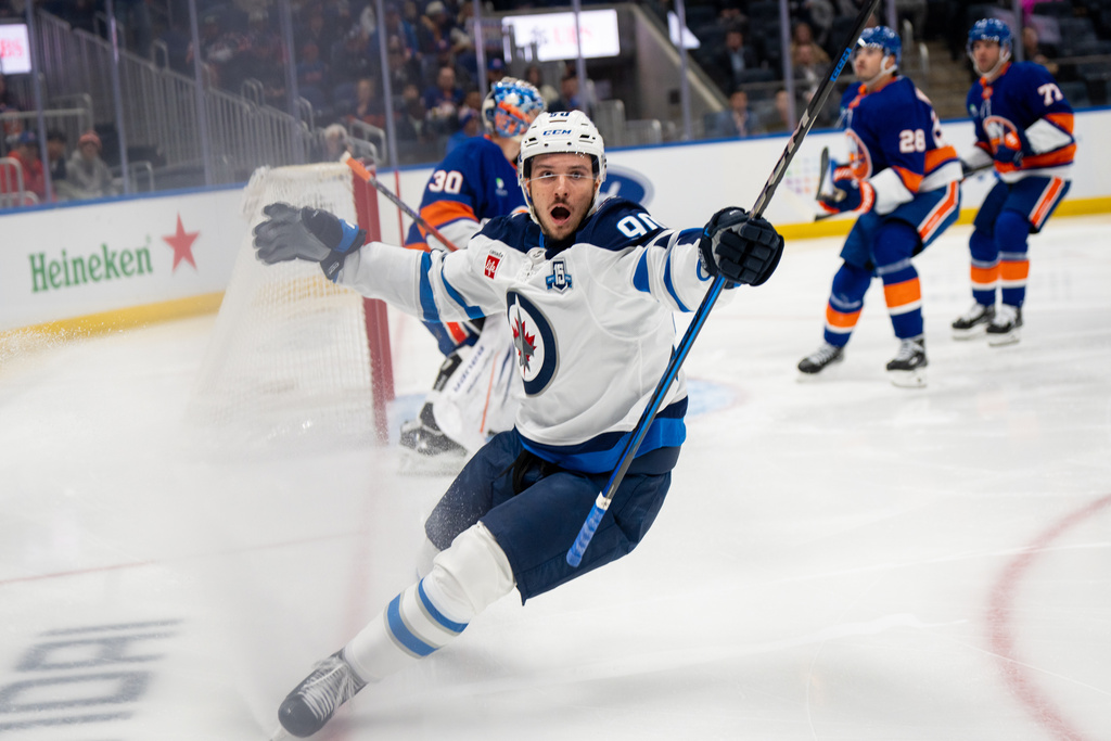 Winnipeg Jets right wing Nikita Chibrikov (90) reacts after a close shot during the first period of an NHL hockey game against the New York Islanders, Monday, Oct. 13, 2025, in Elmont, N.Y. (AP Photo/Angelina Katsanis)
