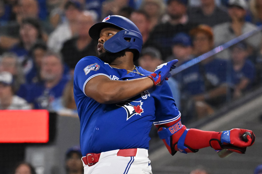 Toronto Blue Jays' Vladimir Guerrero Jr. (27) hits a single against the Chicago White Sox during first inning of a baseball game in Toronto, Saturday, July 18, 2026. (Jon Blacker/The Canadian Press via AP)