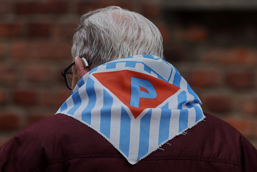 A Holocaust survivor walks in the Auschwitz Nazi death camp museum during a ceremony marking the 81th anniversary of the camp's liberation in Oswiecim, Poland, Tuesday, Jan. 27, 2026. (AP Photo/Beata Zawrzel)