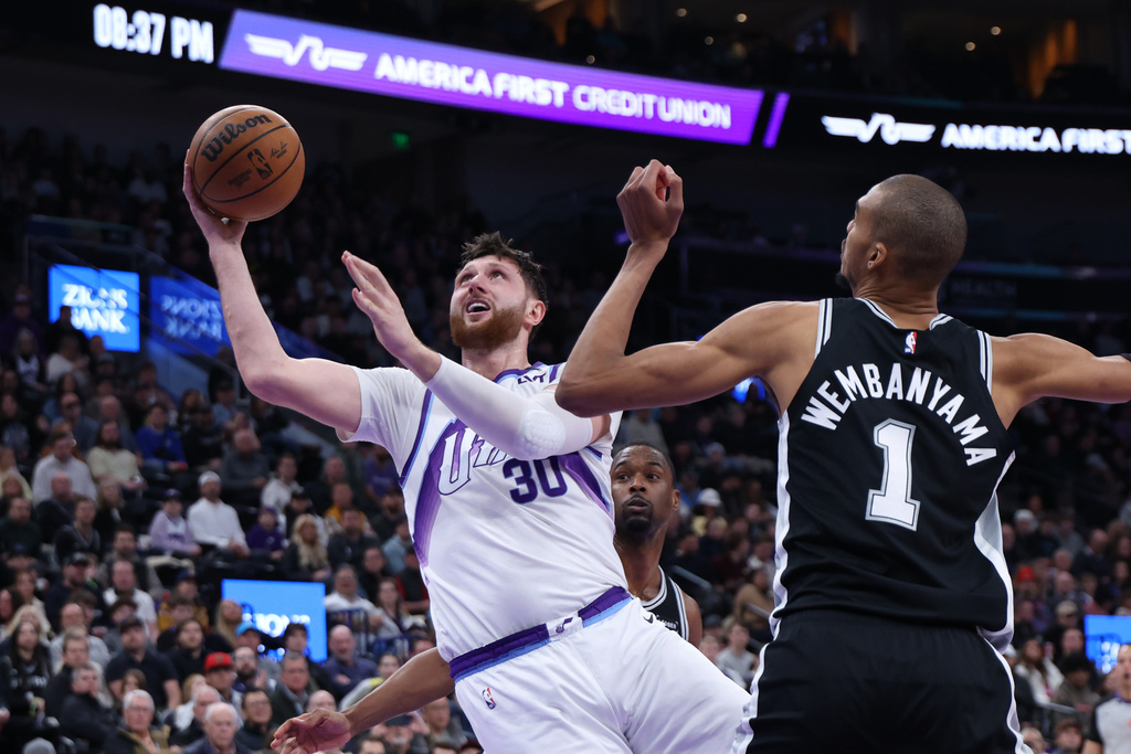 Utah Jazz center Jusuf Nurkic (30) goes to the basket against San Antonio Spurs forward Victor Wembanyama (1) during the second half of an NBA basketball game, Thursday, Jan. 22, 2026, in Salt Lake City. (AP Photo/Rob Gray)