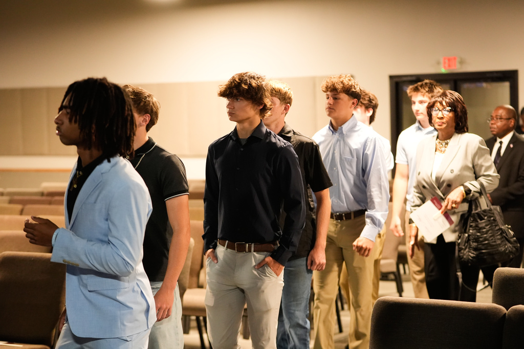 Football teammates of Nolan Xavier Wells, an 18-year-old found dead after taking a July 4 boat trip with friends, attend his memorial service Monday, July 20, 2026, in Ocean Springs, Miss. (AP Photo/Gerald Herbert)