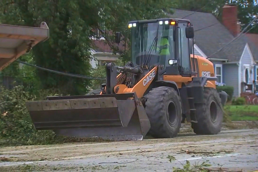 This image made from a video provided by ABC 7 Chicago shows crews working to restore power on Tuesday, Aug. 18, 2026, in Griffith, Ind., more than a week after storms leveled trees and knocked down power lines across the region. (ABC 7 Chicago via AP)