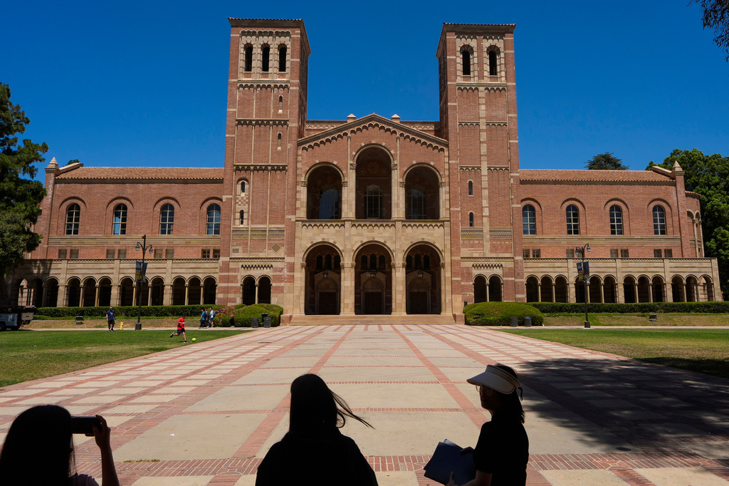 FILE - Visitors take pictures in front of Royce Hall at the University of California's Los Angeles campus on Aug. 15, 2024. (AP Photo/Damian Dovarganes, File)