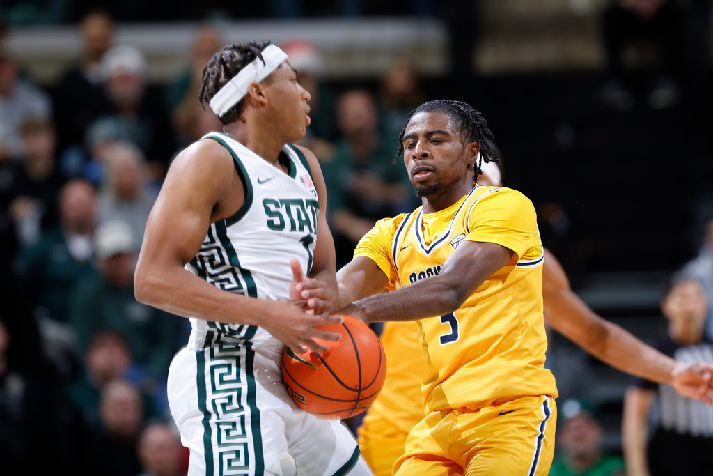 Michigan State guard Jeremy Fears Jr., left, and Toledo guard Sonny Wilson (3) fight for the ball during the first half of an NCAA college basketball game, Tuesday, Dec. 16, 2025, in East Lansing, Mich. (AP Photo/Al Goldis)