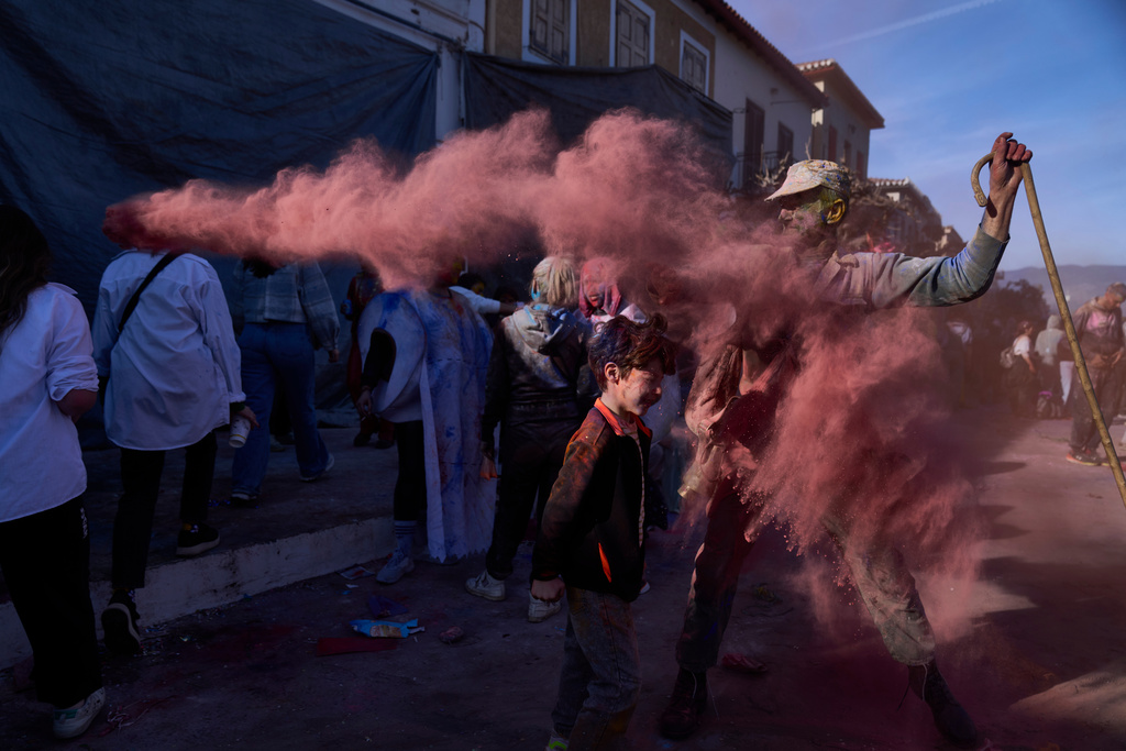 Revelers take part in the annual flour war marking the end of the Carnival season on Clean Monday in Galaxidi, about 200 kilometers (120 miles) west of Athens, Feb. 23, 2026, starting the 40-day Christian Lent fast leading to Easter. (AP Photo/Petros Giannakouris)