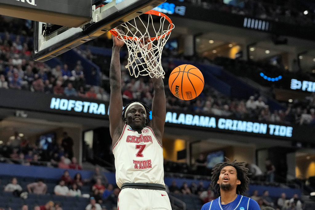 Alabama forward Taylor Bol Bowen (7) slam dunks over Hofstra forward Silas Sunday during the second half in the first round of the NCAA college basketball tournament Friday, March 20, 2026, in Tampa, Fla. (AP Photo/Chris O'Meara)