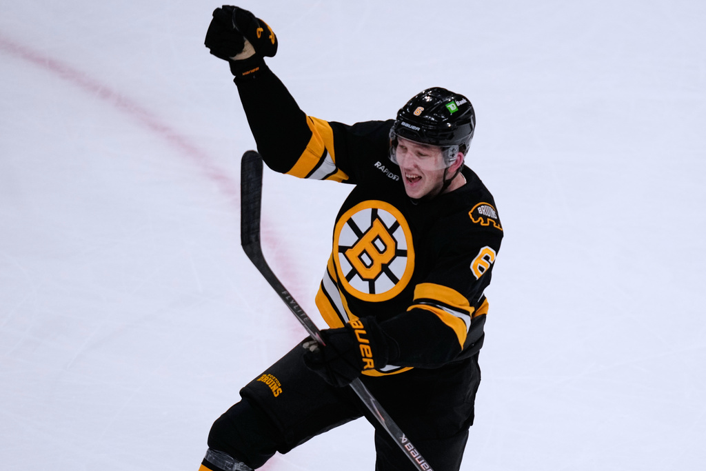 Boston Bruins defenseman Mason Lohrei celebrates after his goal against the Calgary Flames during the second period of an NHL hockey game, Thursday, Jan. 8, 2026, in Boston. (AP Photo/Charles Krupa)