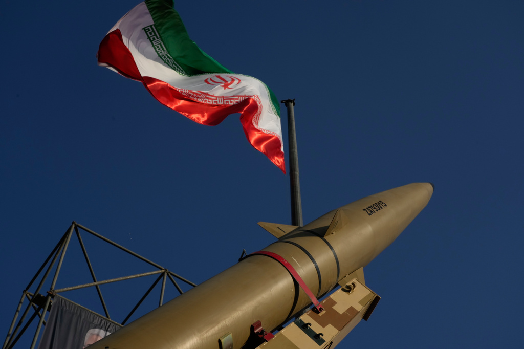 An Iranian missile is displayed under the country's national flag in a military exhibition commemorating the anniversary of the start of the 1980-88 Iraq-Iran war at Baharestan Square, in Tehran, Monday, Sept. 28, 2026. (AP Photo/Vahid Salemi)