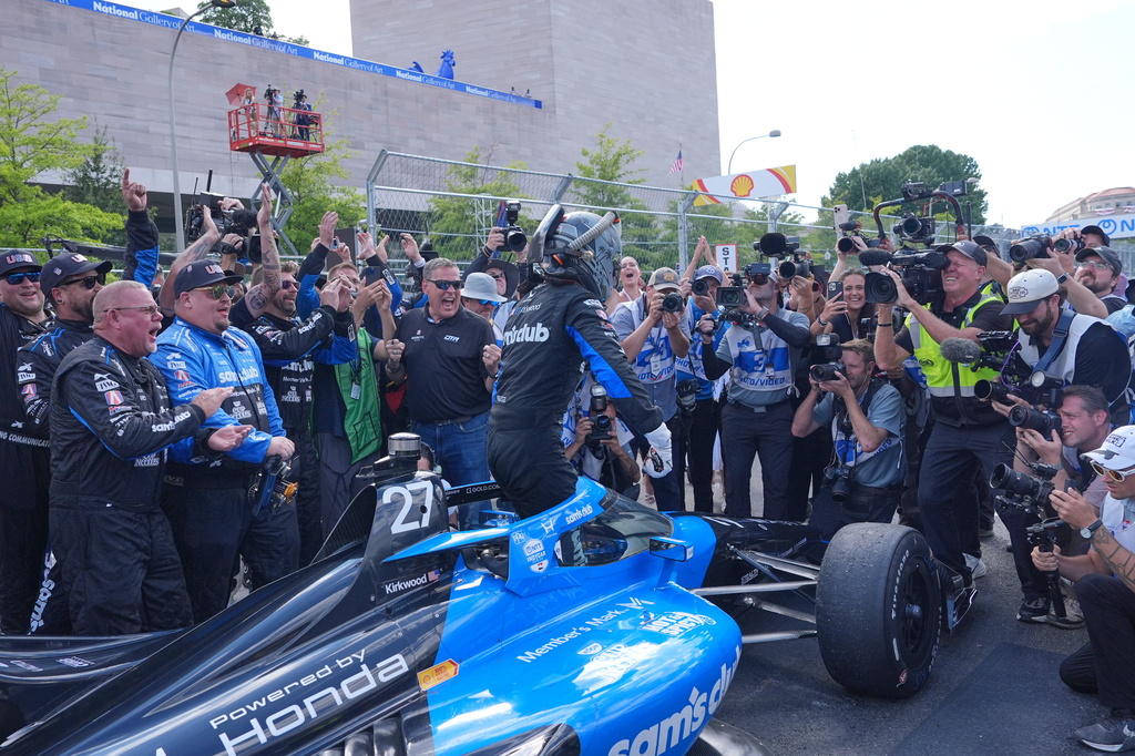Kyle Kirkwood (27) celebrates with his team after winning the IndyCar Freedom 250 Grand Prix auto race in Washington, Sunday, Aug. 23, 2026. (AP Photo/Alex Brandon)