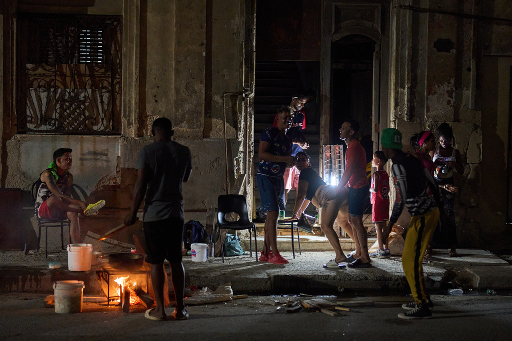 A man prepares caldosa, a traditional soup, during a birthday celebration on the street in Havana, Thursday, March 5, 2026. (AP Photo/Ramon Espinosa)