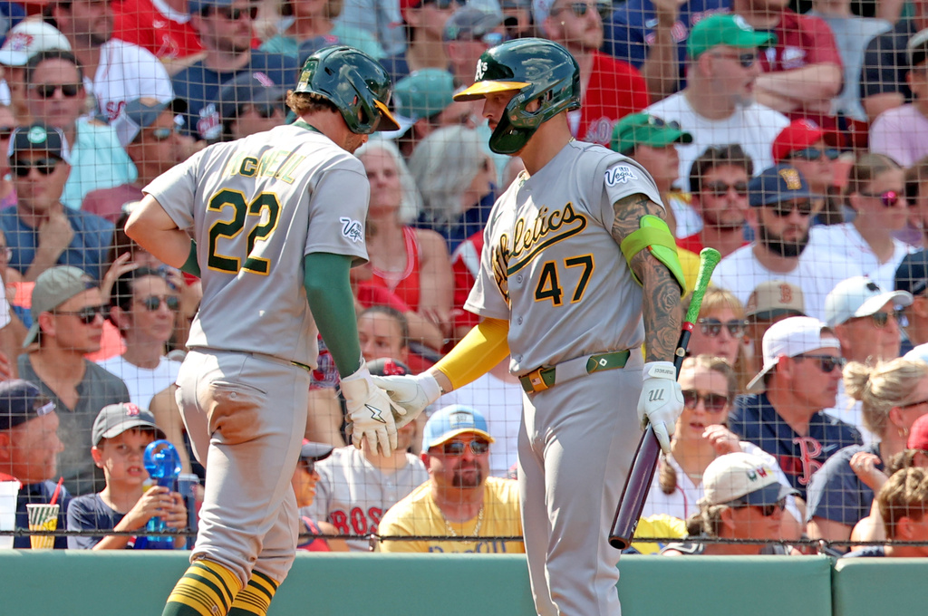 Athletics' Jeff McNeil (22) greetss teammate Tommy White (47) after scoring during the eighth inning of a baseball game against the Boston Red Sox, Sunday, Aug. 9, 2026, in Boston. (AP Photo/Mark Stockwell)