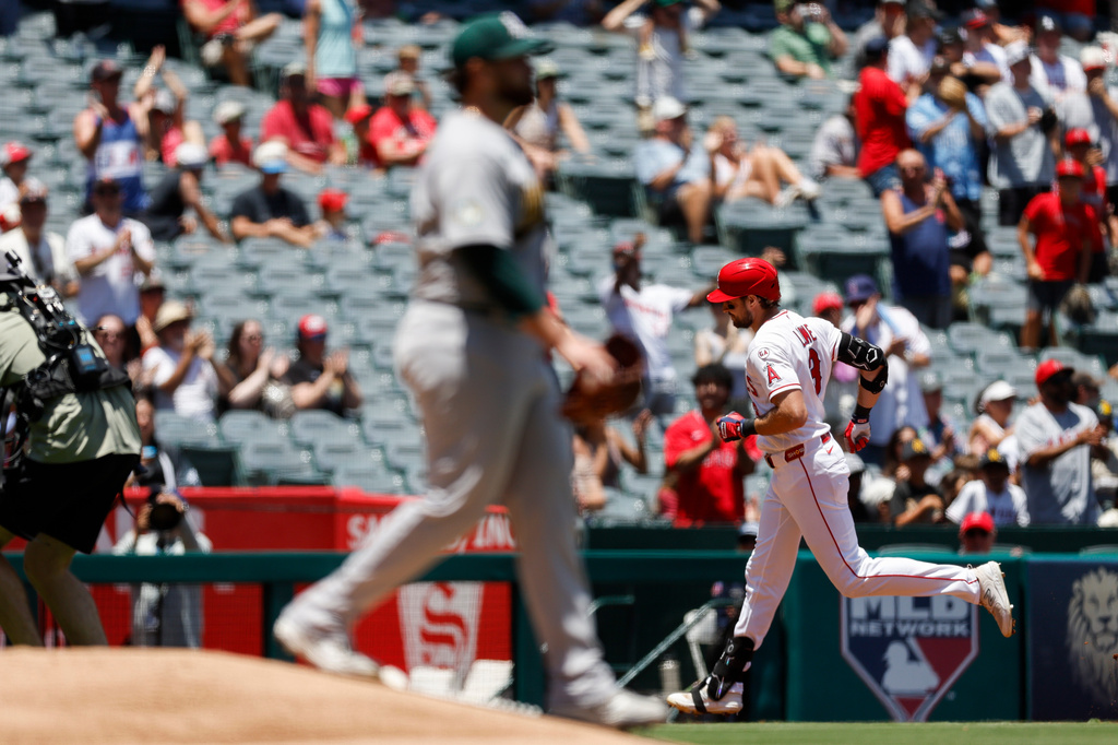 Los Angeles Angels' Josh Lowe, right, rounds the bases after hitting a grand slam as Athletics starting pitcher Aaron Civale, left, looks on during the second inning of a baseball game, Sunday, June 28, 2026, in Anaheim, Calif. (AP Photo/Caroline Brehman)