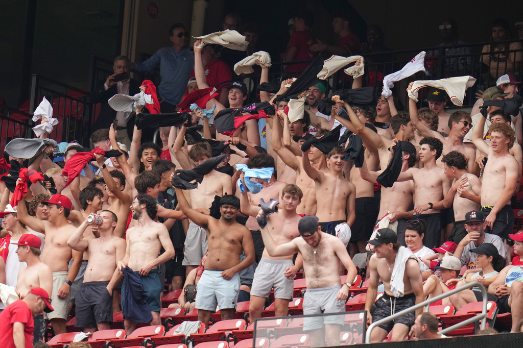 Fans cheer and wave their shirts above their heads during the fourth inning of a baseball game between the St. Louis Cardinals and the Kansas City Royals Saturday, May 16, 2026, in St. Louis. (AP Photo/Jeff Roberson)