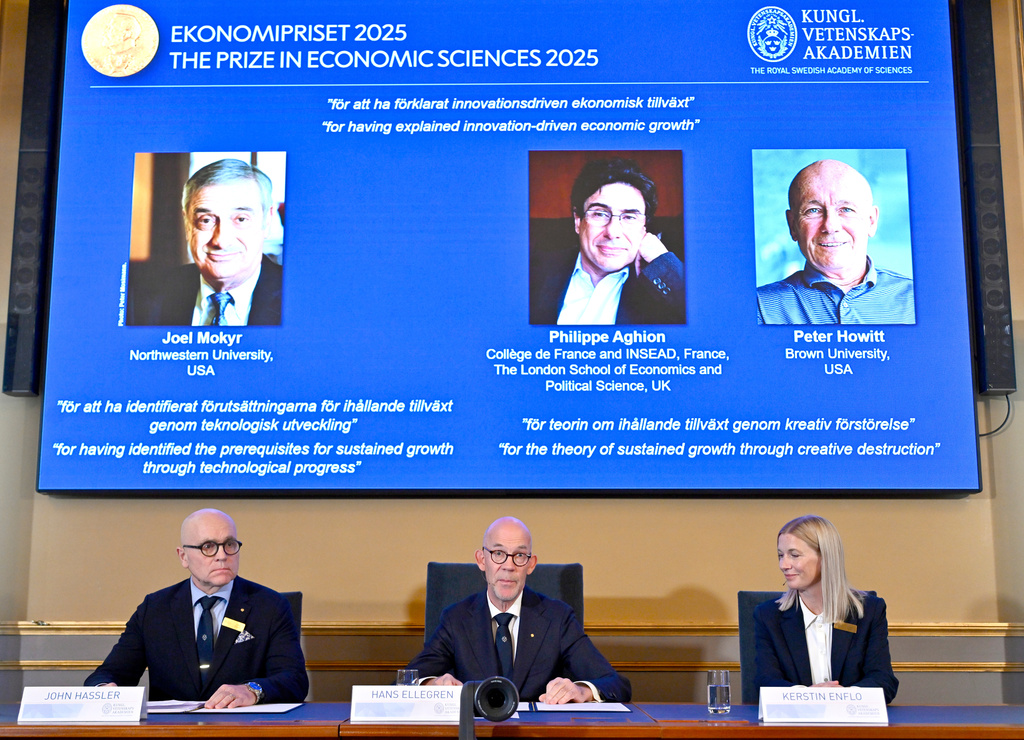 Professor John Hassler, from left, Hans Ellegren, Permanent Secretary of the Academy of Sciences and Professor Kerstin Enflo, announce Joel Mokyr, Philippe Aghion and Peter Howitt as the recipients the Nobel Memorial Prize in Economics during a press conference at the Royal Swedish Academy of Sciences in Stockholm, Sweden, Monday, Oct. 13, 2025. (Anders Wiklund/TT News Agency via AP)