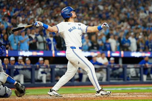 Toronto Blue Jays' Addison Barger watches his grand slam against the Los Angeles Dodgers during the sixth inning of Game 1 of baseball's World Series in Toronto, Friday, Oct. 24, 2025. (Frank Gunn/The Canadian Press via AP) Toronto Blue Jays' Addison Barger watches his grand slam against the Los Angeles Dodgers during the sixth inning of Game 1 of baseball's World Series in Toronto, Friday, Oct. 24, 2025. (Frank Gunn/The Canadian Press via AP)