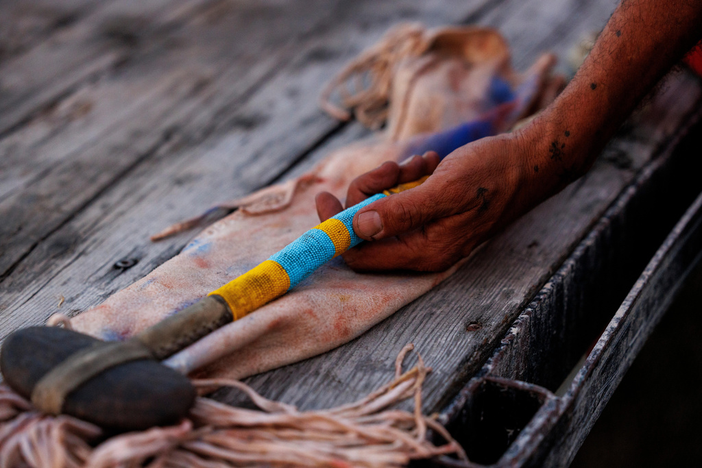 Terry Richard holds the war club that belonged to his grandfather, High Wolf, during festivities to commemorate the 150th anniversary of the Battle of the Little Bighorn, Wednesday, June 24, 2026, in Crow Agency, Mont. (AP Photo/Tailyr Irvine)