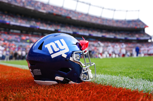 FILE - A New York Giants helmet is shown on the field before an NFL football game between the Denver Broncos and the Giants in Denver on Oct. 19, 2025. (AP Photo/Jack Dempsey, File) FILE - A New York Giants helmet is shown on the field before an NFL football game between the Denver Broncos and the Giants in Denver on Oct. 19, 2025. (AP Photo/Jack Dempsey, File)