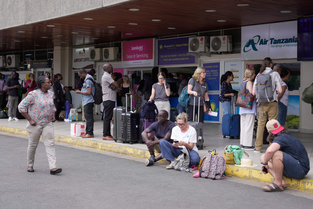 Passengers wait for their delayed flights at Jomo Kenyatta International Airport (JKIA) in Nairobi, Kenya, Monday, Feb. 16, 2026. (AP Photo/Brian Inganga)