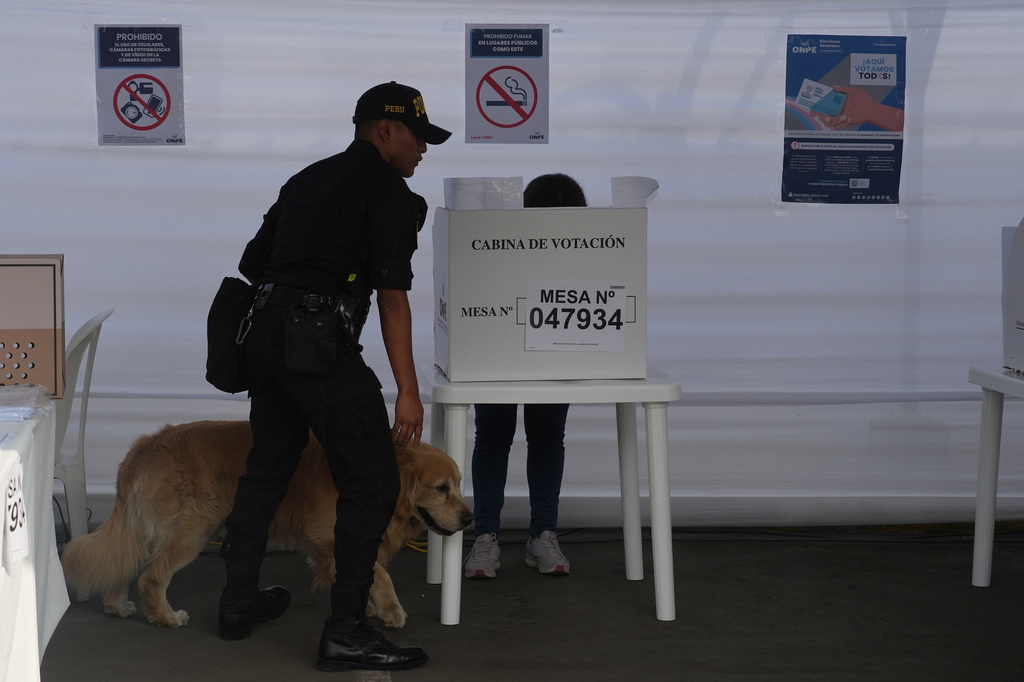Police inspects a polling station during general elections in Lima, Peru, Sunday, April 12, 2026. (AP Photo/Guadalupe Pardo)