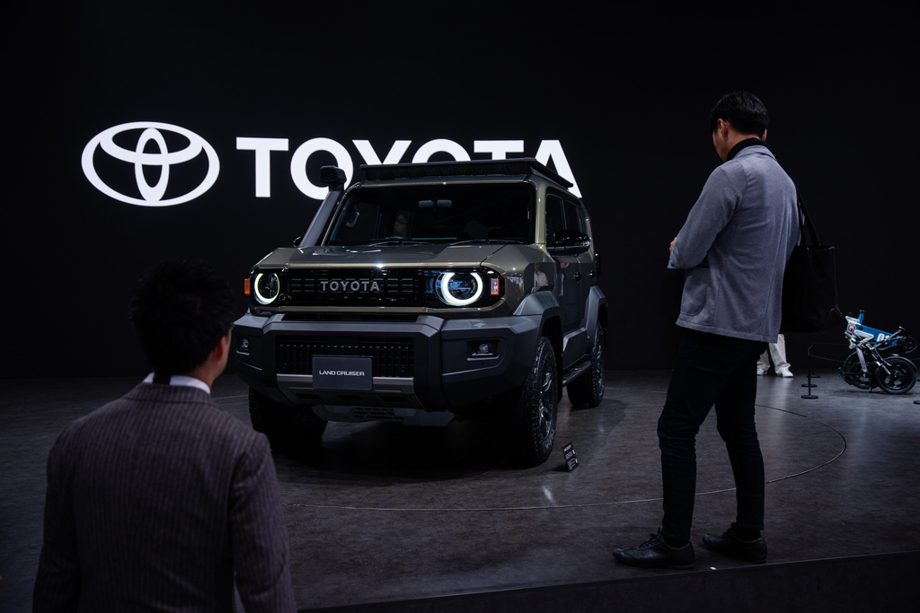 FILE - Members of the media and guests look at Toyota's Land Cruiser 'FJ' during the press day of the Japan Mobility Show, in Tokyo, Oct. 30, 2025. (AP Photo/Louise Delmotte, File)