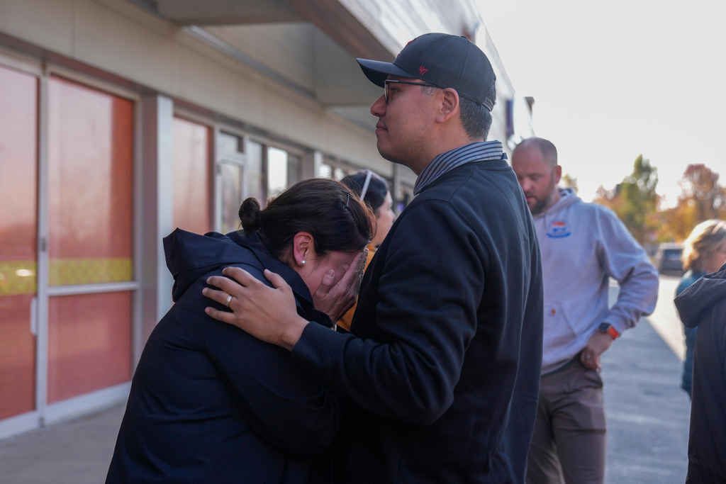 Maria Guzman, left, and Sergio Rocha, parents of young children, comfort each other outside of Rayito de Sol Spanish Immersion Early Learning Center after an employee of the preschool was arrested by federal immigration agents, Wednesday, Nov. 5, 2025, in Chicago. (AP Photo/Erin Hooley)