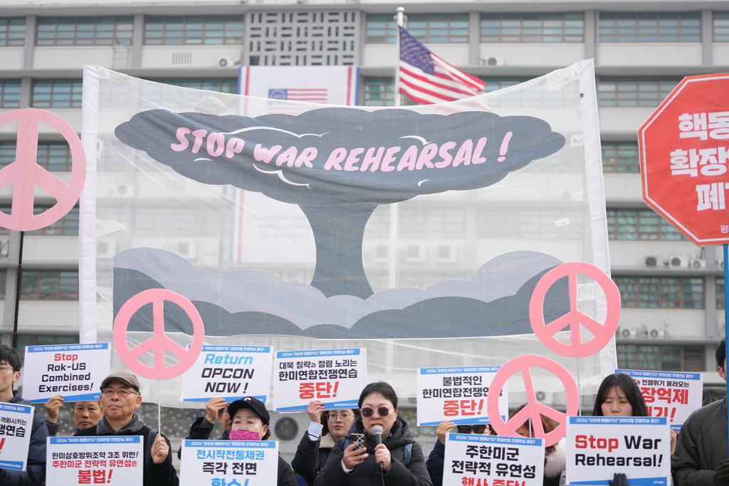 Protesters hold signs to oppose the joint military exercise between the U.S. and South Korea, near the U.S. Embassy in Seoul, South Korea, Monday, March 9, 2026. (AP Photo/Lee Jin-man)