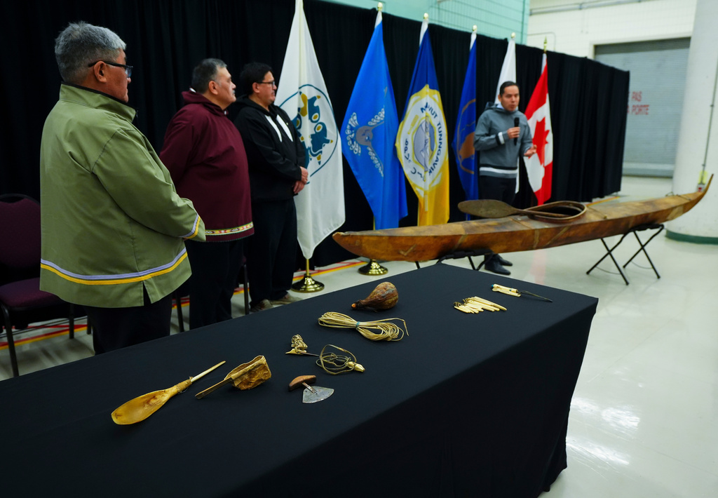 Paul Irngaut, Acting President of Nunavut Tunngavik Inc., left to right, Darrel Nasogaluak, Elder and Chair of Tuktoyaktuk Community Corp., Duane Smith, Chair and CEO of the Inuvialuit Regional Corp., and Natan Obed, President of Inuit Tapiriit Kanatami unveil a traditionally built Inuvialuit kayak and a selection of Inuit items at the Canadian Museum of History in Gatineau, Que., on Tuesday, Dec. 9, 2025. (Sean Kilpatrick /The Canadian Press via AP)