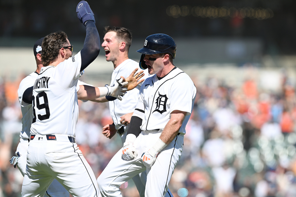 Detroit Tigers' Kevin McGonigle, right, celebrates with his teammates Zach McKinstry, left, and Zack Short, center, after hitting a two-run walk-off single against the Seattle Mariners in the ninth inning of a baseball game, Sunday, June 7, 2026, in Detroit. (AP Photo/Lon Horwedel)
