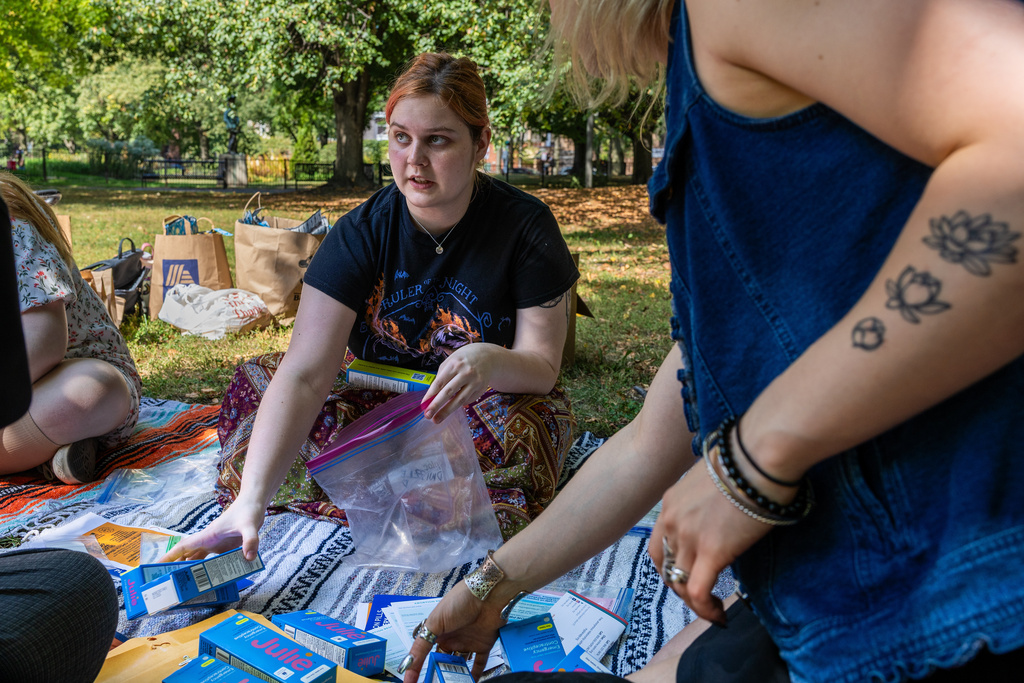 DePaul University freshman Anna Daniel, 19, assembles a kit of contraceptive supplies at Oz Park in Chicago on Sunday, Sept. 28, 2025. (AP Photo/Heidi Zeiger)