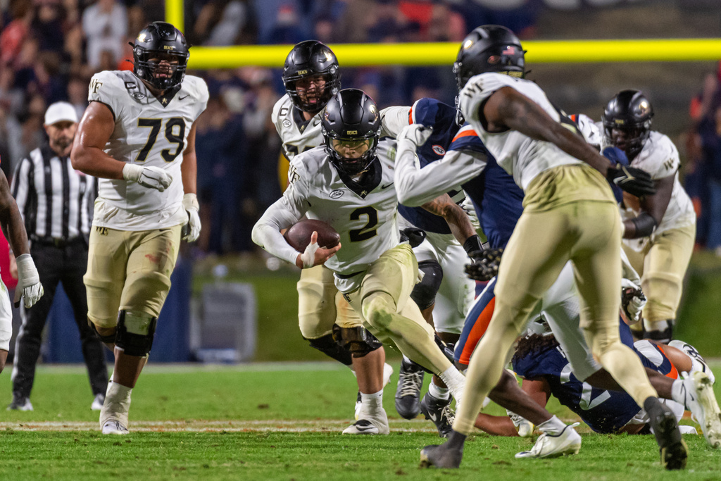 Wake Forest quarterback Robby Ashford (2) runs up the middle against Virginia during the second half of an NCAA college football game, Saturday, Oct. 4, 2025, in Charlottesville, Va. (AP Photo/Robert Simmons)