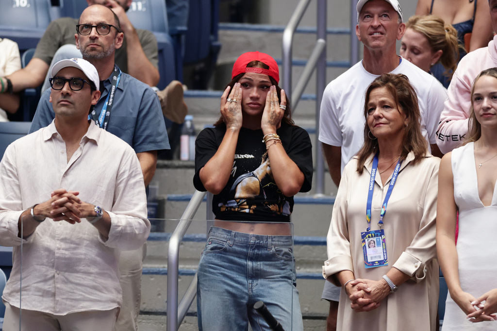 Soccer player Trinity Rodman, center, reacts after her boyfriend Ben Shelton, of the United States, lost the men's singles final of the U.S. Open tennis championships against Alexander Zverev, of Germany, Sunday, Sept. 13, 2026, in New York. (AP Photo/Adam Hunger)