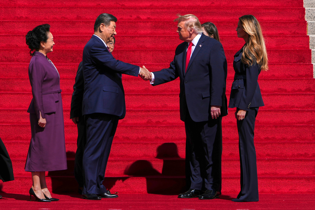 President Donald Trump, center right, shakes the hand of China's President Xi Jinping as first lady Melania Trump, right, and China's first lady Peng Liyuan, left, watch as they arrive at the National Archives Museum, Friday, Sept. 25, 2026, in Washington. (AP Photo/Julia Demaree Nikhinson)