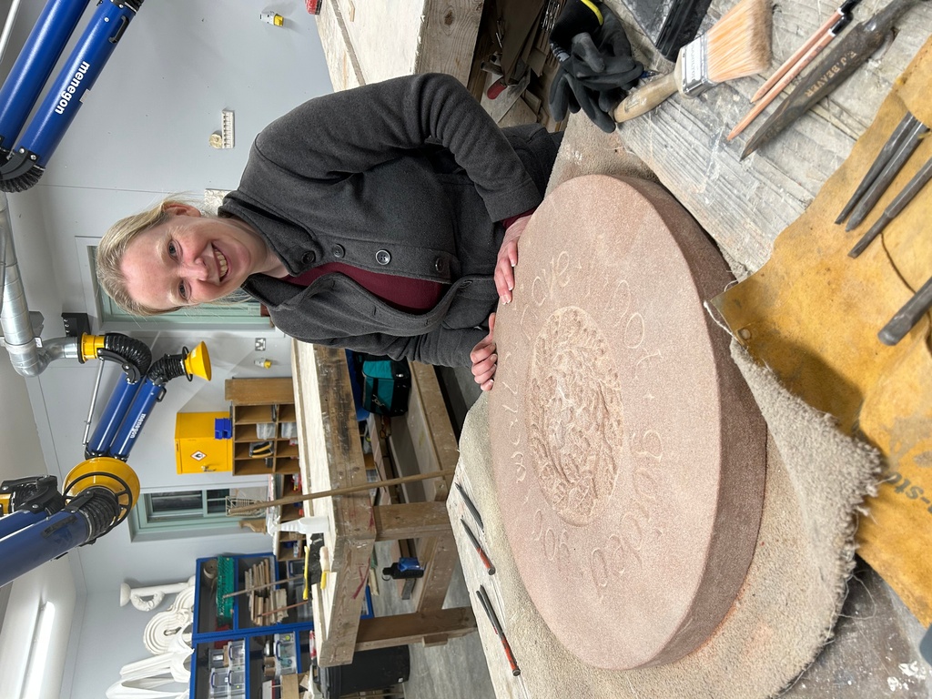 Jennie Regan stands beside the stone she carved with an inscription from a Scottish fairy tale at Dumfries House in Cumnock, Scotland, Nov. 26, 2025. (AP Photo/Danica Kirka)