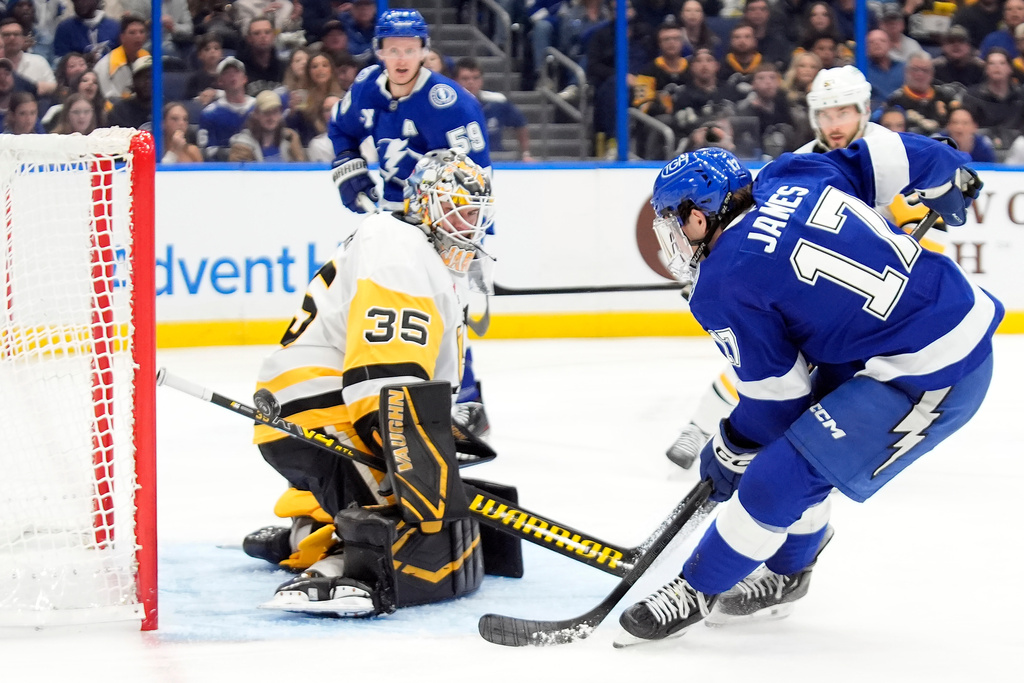 Pittsburgh Penguins goaltender Tristan Jarry (35) stops a shot by Tampa Bay Lightning center Dominic James (17) during the second period of an NHL hockey game Thursday, Dec. 4, 2025, in Tampa, Fla. (AP Photo/Chris O'Meara)