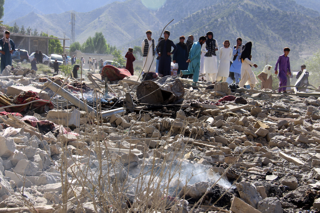 Residents walk through the rubble after what Taliban officials said were Pakistani airstrikes a day earlier that killed civilians, including children, in the village of Mandokhail, Chamkani district, Paktia province, Afghanistan, Monday, June 29, 2026. (AP Photo/Saifullah Zahir)