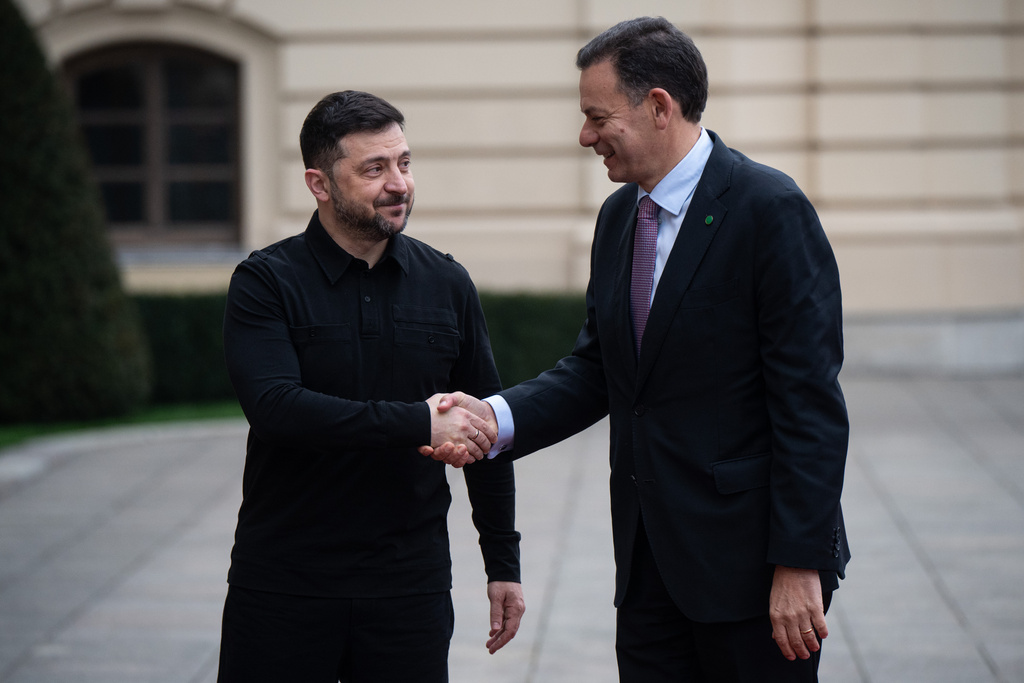 Ukraine's President Volodymyr Zelenskyy, left, shakes hands with Portuguese Prime Minister Luís Montenegro in Kyiv, Ukraine, Saturday, Dec. 20, 2025. (AP Photo/Danylo Antoniuk)