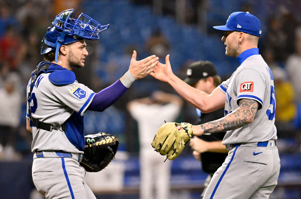 Kansas City Royals catcher Carter Jensen, left, and pitcher Alex Lange, right, celebrate after a win over the Tampa Bay Rays in a baseball game Monday, June 22, 2026, in St. Petersburg, Fla. (AP Photo/Jason Behnken)